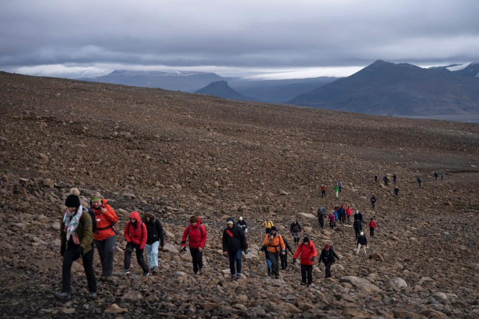 Hikers climb to what was the Okjokull ice sheet. (AP)