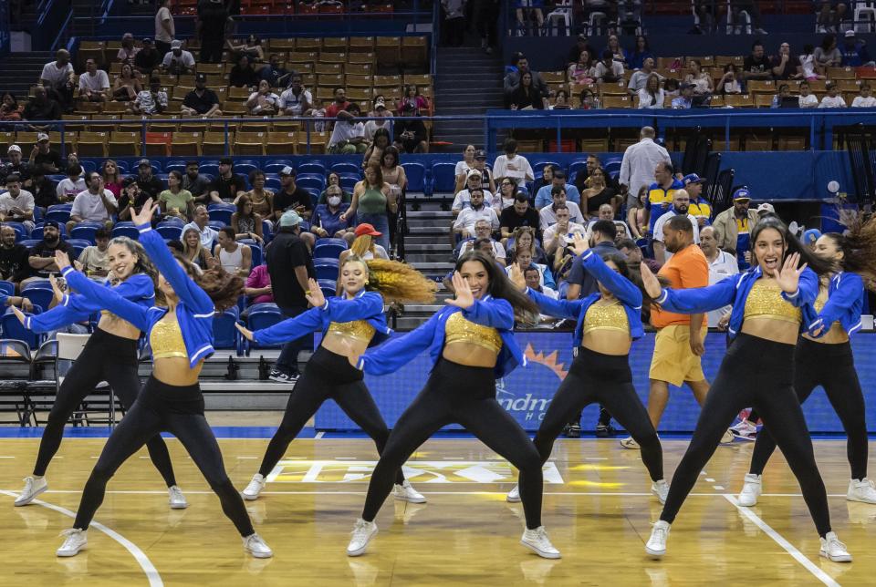 Dancers perform in a halftime show during a basketball game between the Bayamón Vaqueros and the Guaynabo Mets, in Bayamón, Puerto Rico, Monday, July 1, 2024. Puerto Rico’s professional basketball league is experiencing a renaissance thanks to reggaeton stars like Bad Bunny, Ozuna and Anuel AA, who are stepping into the financial game, buying local teams and helping to stack up a loyal fan base. (AP Photo/Alejandro Granadillo)