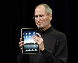 File - Apple CEO Steve Jobs shows off the new iPad during an event in San Francisco, Wednesday, Jan. 27, 2010. The tablet provided people with a quicker, more convenient way to browse the web, check email, and read books than a laptop on a larger screen than smartphones. (AP Photo/Paul Sakuma)