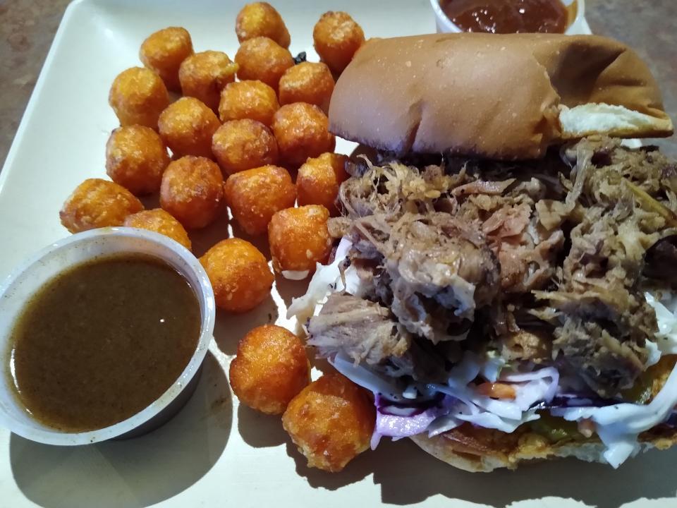 A pulled pork sandwich is served with sweet potato tots at Great Oaks Tavern in Wadsworth. The house-made sauces include cinnamon and barbecue.