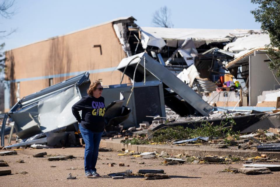Anne Adams, the principal of Crestview Elementary, looks at the damage to the school and surrounding area in Covington on April 1, 2023. An EF3 tornado hit the area on March 31.