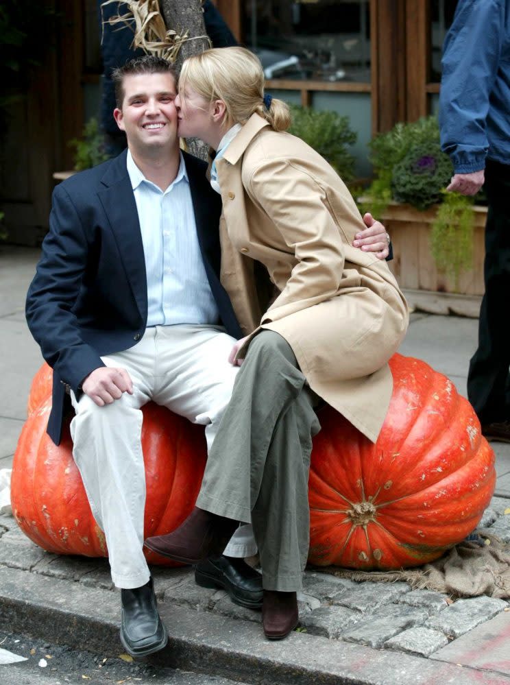 Donlad Trump Jr. was all smiles while receiving a smooch. (Photo: Splash News)