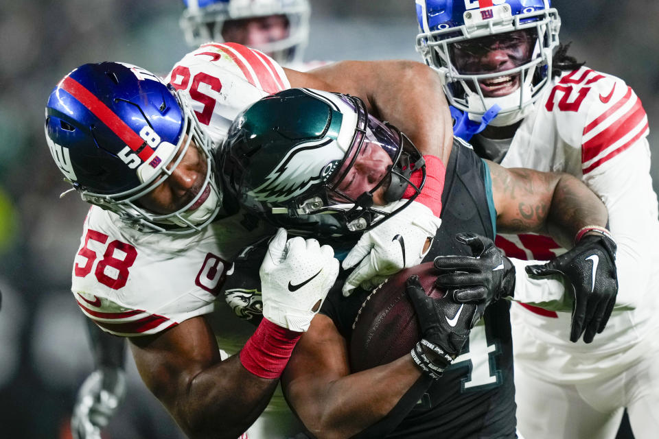 Philadelphia Eagles running back Kenneth Gainwell is tackled by New York Giants linebacker Bobby Okereke during the second half of an NFL football game Monday, Dec. 25, 2023, in Philadelphia. (AP Photo/Matt Slocum)