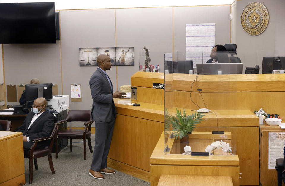 Defense attorney Kobby Warren, center, asks Judge Raquel "Rocky" Jones, right, about the motions and language being sent to the jury after one juror is hanging up the deliberations in the capital murder trial of Billy Chemirmir, left at the Frank Crowley Courts Building in Dallas, Friday, Nov. 19, 2021. Chemirmir, 48, faces life in prison without parole if convicted of capital murder for smothering Lu Thi Harris, 81, and stealing her jewelry. He is accused of killing at least 18 women in Dallas and Collin counties. (Tom Fox/The Dallas Morning News via AP, Pool)