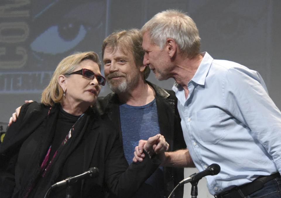 FILE - In this Friday, July 10, 2015 file photo, from left, Carrie Fisher, Mark Hamill and Harrison Ford attend a panel at Comic-Con International in San Diego, Calif. On Tuesday, Dec. 27, 2016, a family publicist said Fisher died at the age of 60. With the loss of several icons of Generation X’s youth, the year 2016 has left the generation born between the early 1960s and the early 1980s, wallowing in memories and contemplating its own mortality. (Photo by Richard Shotwell/Invision/AP)