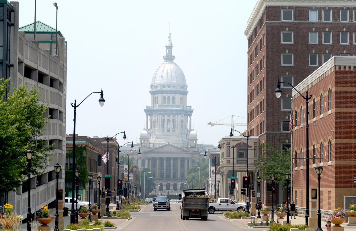 The Illinois state Capitol surrounded by a light haze Tuesday, June 27, 2023.