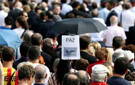 A placard reading "Peace" is seen during a ceremony in memory of victims of the twin Islamist attacks on the Catalan capital and the coastal town of Cambrils that killed 16 people marking the first anniversary of the attacks at Plaza Catalunya, central Barcelona, Spain, August 17, 2018. REUTERS/Albert Salame