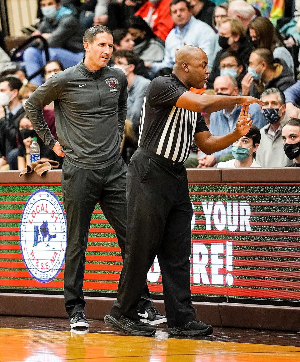 Brown head coach Mike Martin talks with a referee after the Bears were given a technical foul in the first half.