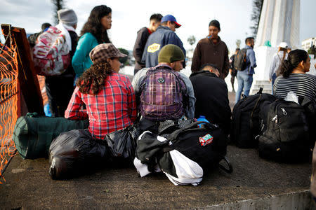 People rest before departing with a caravan of migrants from El Salvador en route to the United States, in San Salvador, El Salvador, October 28, 2018. REUTERS/ Jose Cabezas