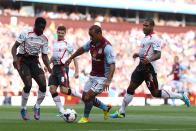 Aston Villa's Gabriel Agbonlahor (centre) is surrounded by Liverpool's Kolo Toure (left) and Glen Johnson (right)
