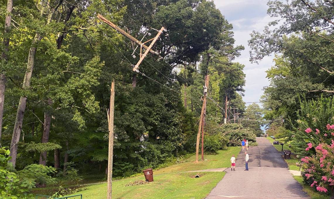 Power poles are snapped on Alpine Road in Durham, N.C., after a powerful storm blew through Tuesday, August 15, 2023.