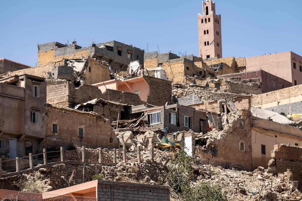 The minaret of a mosque stands behind damaged or destroyed houses following an earthquake in Moulay Brahim, Al-Haouz province, on September 9, 2023 (AFP via Getty Images)