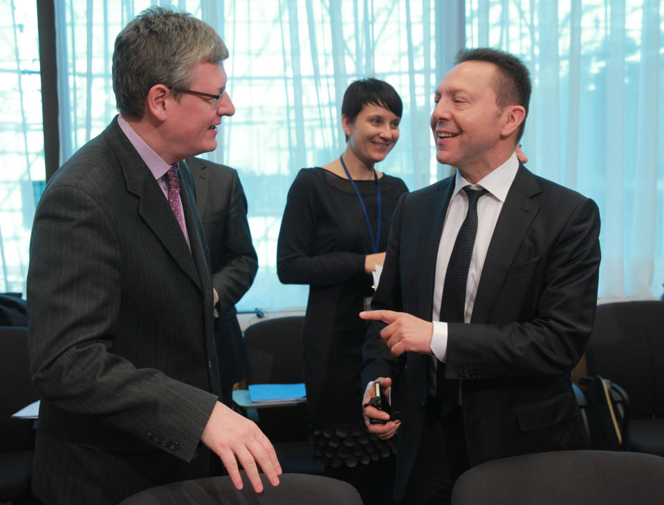 Greek Finance Minister Yannis Stournaras, right, talks with European Commissioner for Employment, Social Affairs and Inclusion Laszlo Andor, during the macro economic dialogue meeting at the European Council building in Brussels, Monday, March 10, 2014. (AP Photo/Yves Logghe)