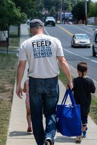 Faces of Hope campaign - Food Lion associate helps distribute food and hope to children in need