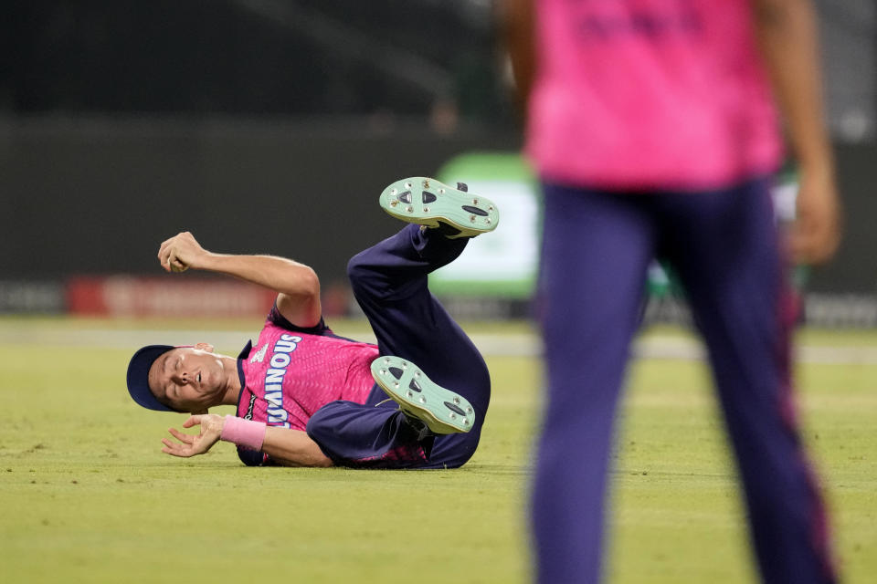 Rajasthan Royals' Trent Boult falls on the ground after taking the catch to dismiss Kolkata Knight Riders' Venkatesh Iyer during the Indian Premier League cricket match between Kolkata Knight Riders and Rajasthan Royals in Kolkata, India, Thursday, May 11, 2023. (AP Photo/Bikas Das)