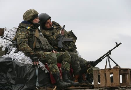 Members of the Ukrainian armed forces ride on an armoured personnel carrier near Artemivsk, eastern Ukraine, March 3, 2015. REUTERS/Gleb Garanich