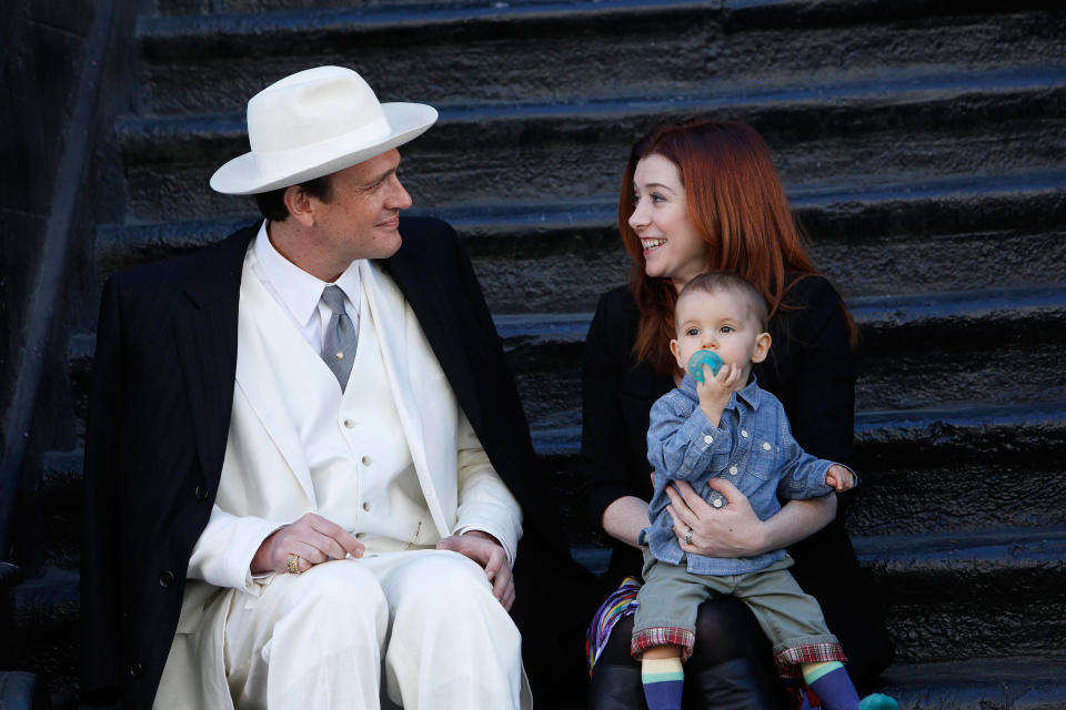 Alyson with Jason Segel and a baby sitting together on steps