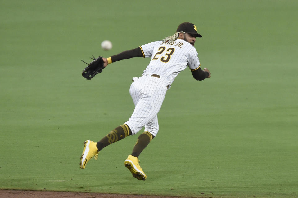 San Diego Padres shortstop Fernando Tatis Jr. throws to first base on a single hit by Seattle Mariners' Evan White during the third inning of a baseball game Friday, Sept. 18, 2020, in San Diego. White was safe at first base. (AP Photo/Denis Poroy)