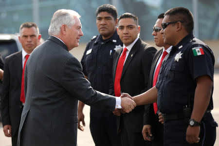 U.S. Secretary of State Rex Tillerson shakes hands with police officers and security personnel as he boards a plane to depart Benito Juarez international Airport in Mexico City, Mexico February 23, 2017. REUTERS/Carlos Barria