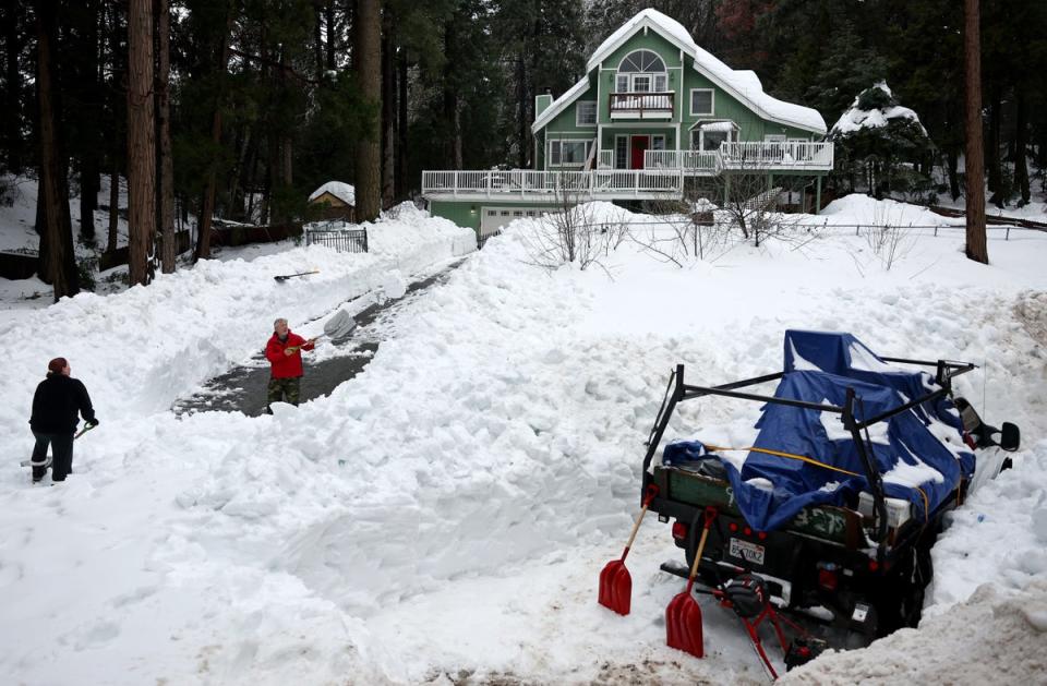 Residents attempt to shovel out their driveway in Crestline this week (Getty Images)