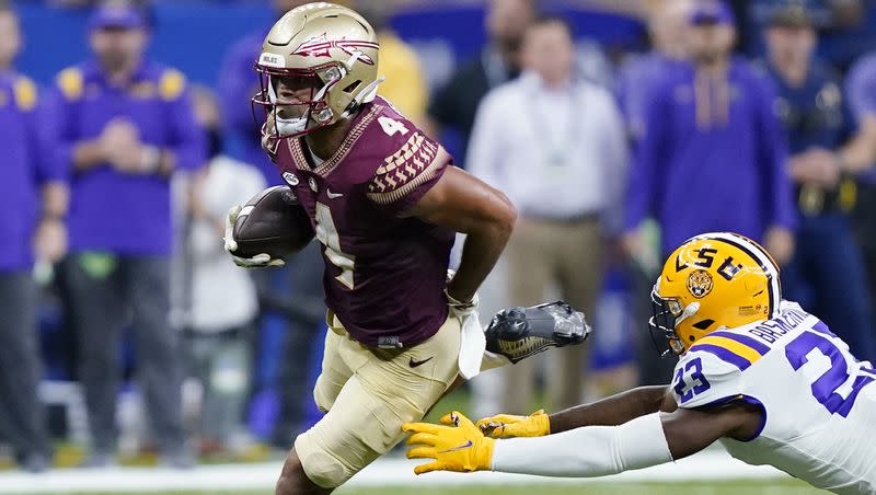 FILE — Florida State wide receiver Mycah Pittman (4) carries against LSU linebacker Micah Baskerville (23) in the second half of an NCAA college football game in New Orleans, Sunday, Sept. 4, 2022. Florida State won 24-23. 