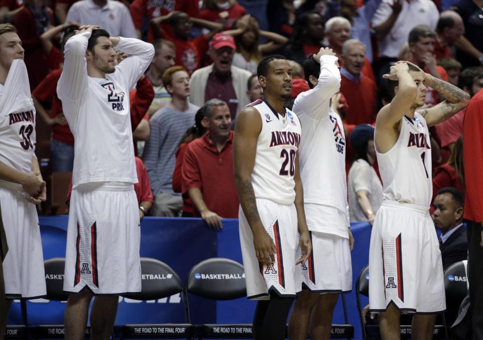 The Arizona bench reacts to a foul during overtime in a regional final NCAA college basketball tournament game against Wisconsin, Saturday, March 29, 2014, in Anaheim, Calif. (AP Photo/Jae C. Hong)