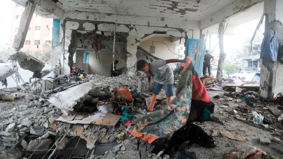 PHOTO: Palestinians look at the aftermath of the Israeli strike on a U.N.-run school that killed dozens of people in the Nusseirat refugee camp in the Gaza Strip, June 6, 2024. (Ismael Abu Dayyah/AP)