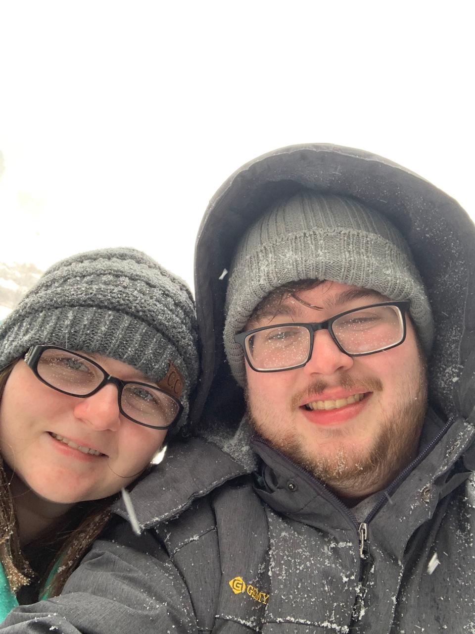 kayla and matthew wilson smiling in the camera in snow gear