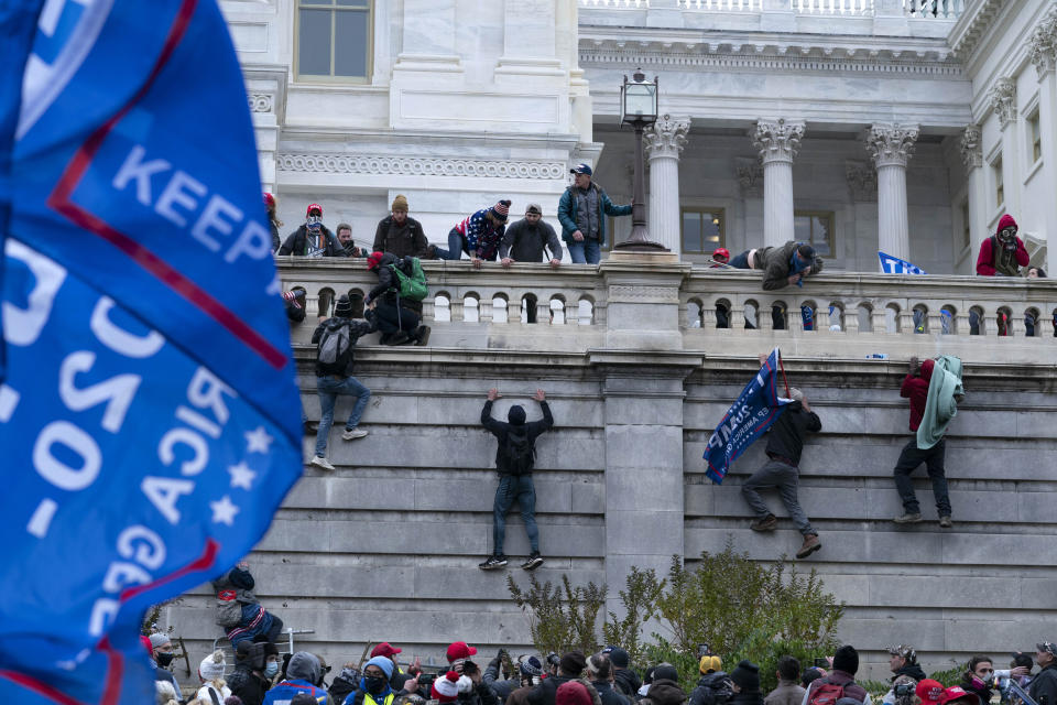 Supporters of President Donald Trump climb the west wall of the the U.S. Capitol on Wednesday, Jan. 6. (Photo: AP Photo/Jose Luis Magana)