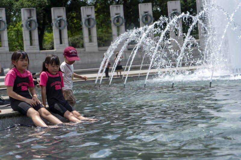 Kids roll up their pants to cool off in the Rainbow Pool at the World War II Memorial in Washington, D.C., on July 5. An extreme heat wave has 143 million people in 19 U.S. states under heat alerts Thursday. Photo by Bonnie Cash/UPI