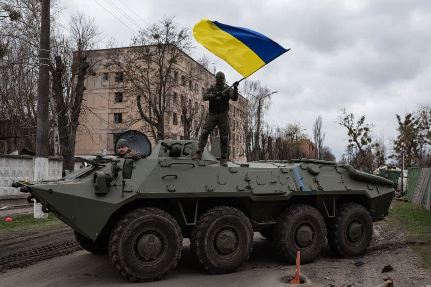 A Ukrainian soldier waves a flag