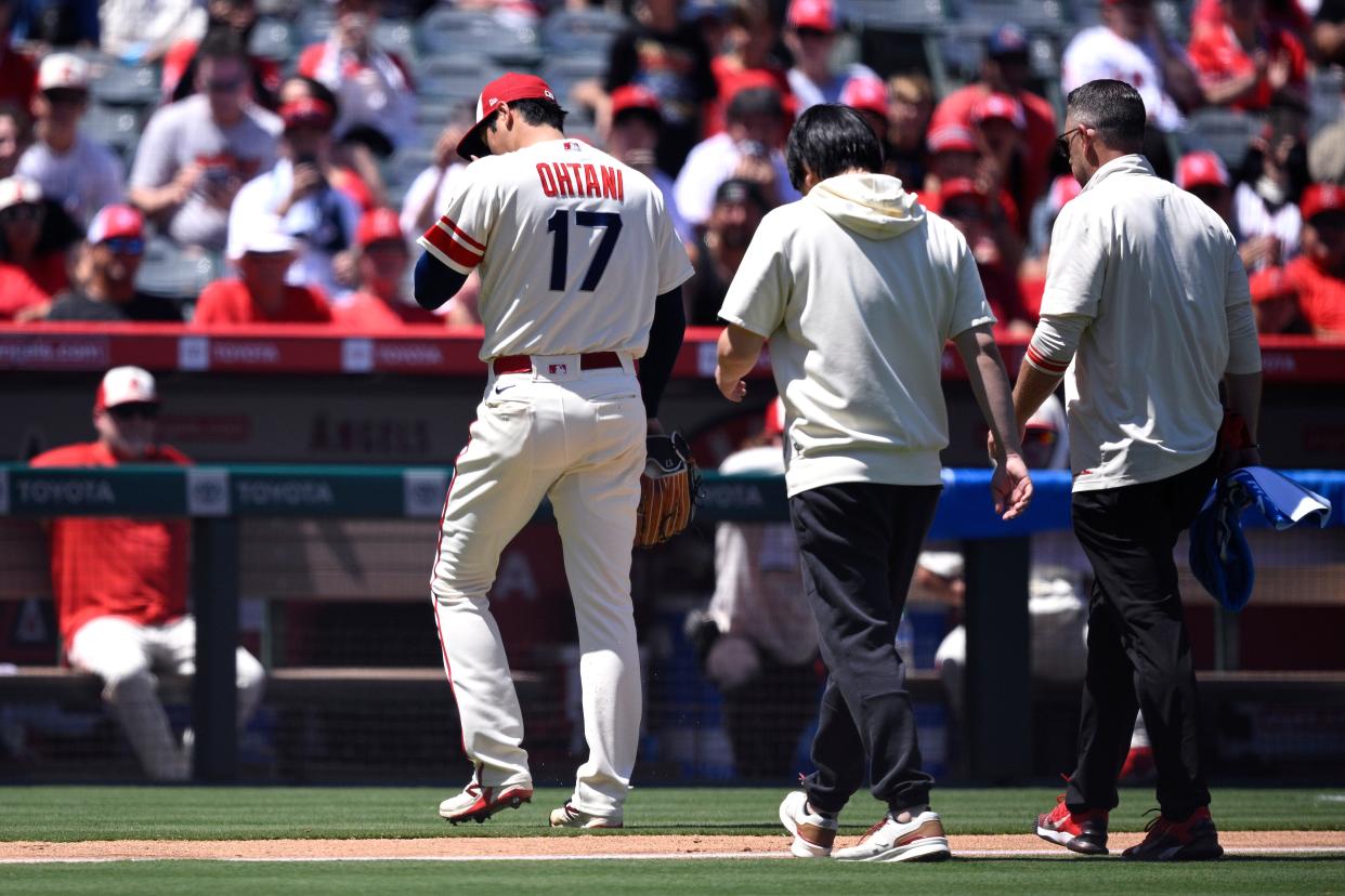 Angels starting pitcher Shohei Ohtani is removed from the game after an apparent injury.