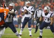 New England Patriots quarterback Tom Brady (12) looks to pass the ball during the first half against the Denver Broncos at Sports Authority Field at Mile High. Mandatory Credit: Chris Humphreys-USA TODAY Sports