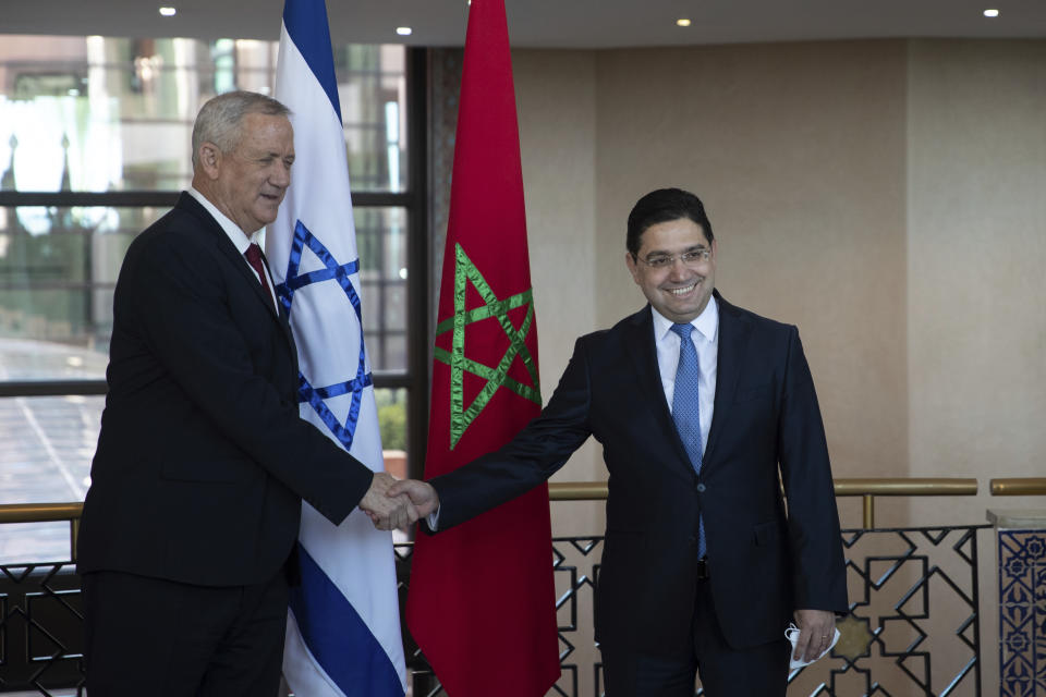 Israeli Defence Minister Benny Gantz, left, is welcomed by Morocco's Foreign Minister Nasser Bourita, right, in Rabat, Morocco, Wednesday, Nov. 24, 2021. Israel and Morocco signed a landmark agreement Wednesday that lays the foundation for security cooperation, intelligence sharing, and future arms sales. (AP Photo/Mosa'ab Elshamy)