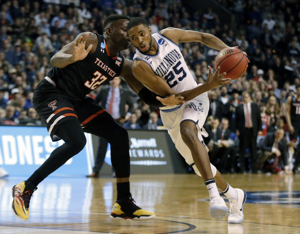 Villanova’s Mikal Bridges (right) tries to drive past Texas Tech’s Norense Odiase during the Wildcats’ East Regional victory. (AP)