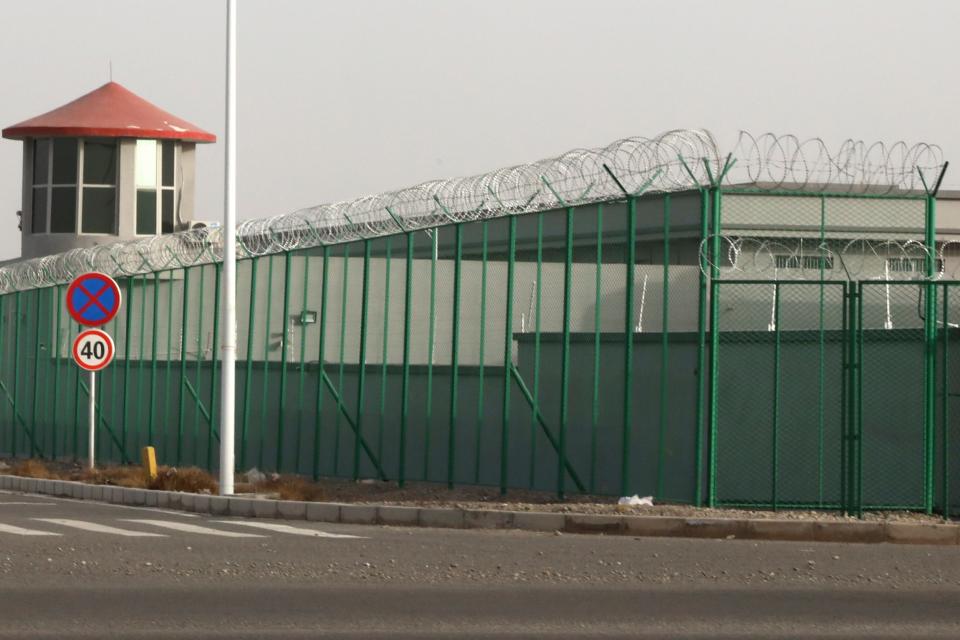 A guard tower and barbed wire fence surround a detention facility in the Kunshan Industrial Park in Artux in western China's Xinjiang region (file photo) AP