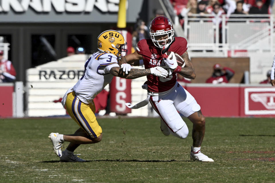 Arkansas wide receiver Jadon Haselwood (9) tries to shake LSU safety Greg Brooks Jr. (3) as he runs for a gain during the first half of an NCAA college football game Saturday, Nov. 12, 2022, in Fayetteville, Ark. (AP Photo/Michael Woods)