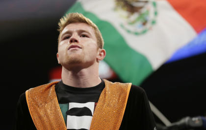 Alvarez enters the ring prior to his fight against Lara. (AP)