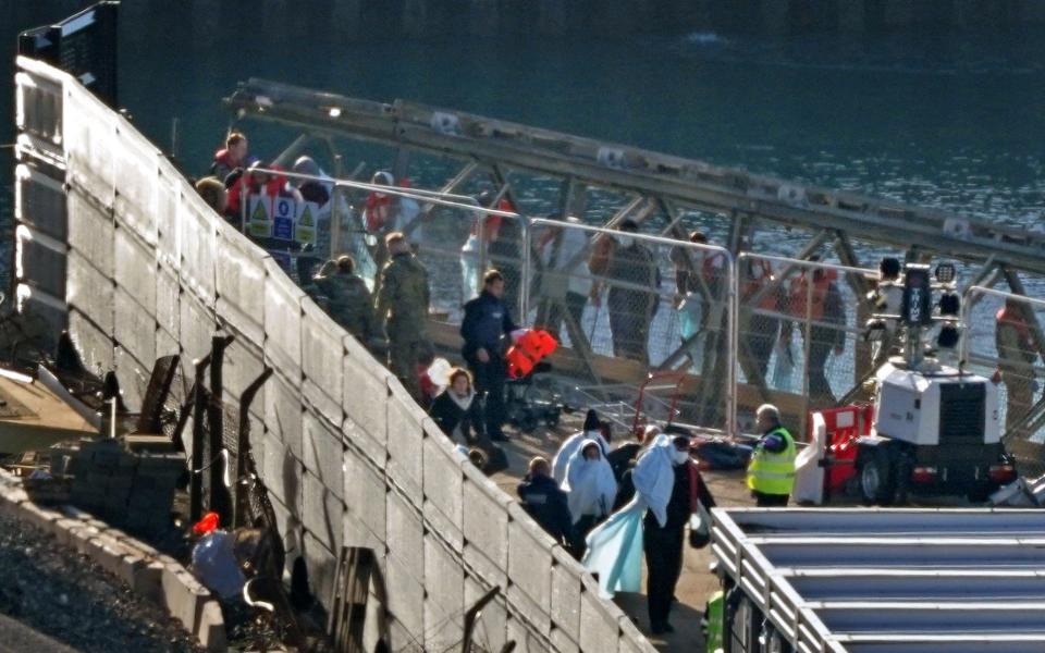 A group of people thought to be migrants walk through the Border Force compound in Dover, Kent, following a small boat incident in the Channel - PA