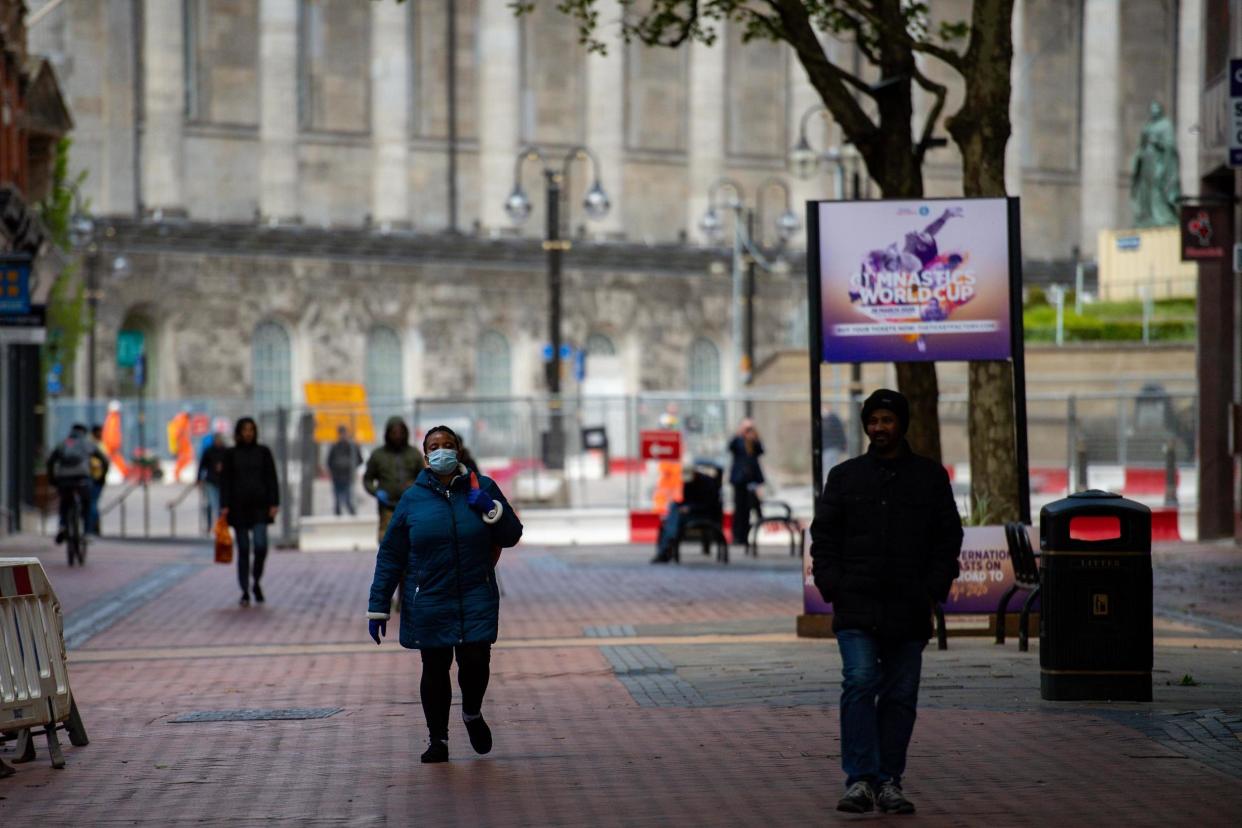 Pedestrians walking on Hill Street in Birmingham city centre, as the UK continues in lockdown to help curb the spread of the coronavirus: PA