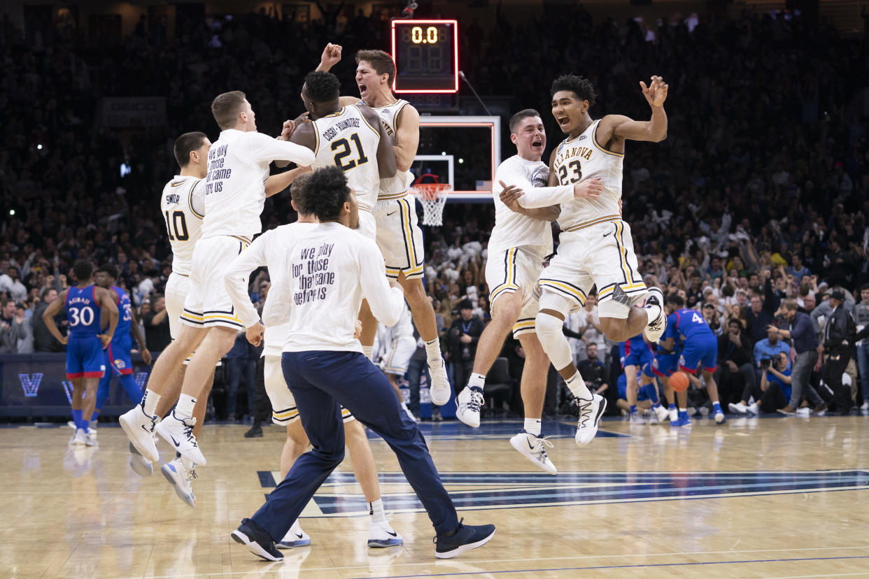 PHILADELPHIA, PA - DECEMBER 21: Cole Swider #10, Dhamir Cosby-Roundtree #21, Collin Gillespie #2, and Jermaine Samuels #23 of the Villanova Wildcats celebrate with their teammates after defeating the Kansas Jayhawks at the Wells Fargo Center on December 21, 2019 in Philadelphia, Pennsylvania. The Villanova Wildcats defeated the Kansas Jayhawks 56-55. (Photo by Mitchell Leff/Getty Images)