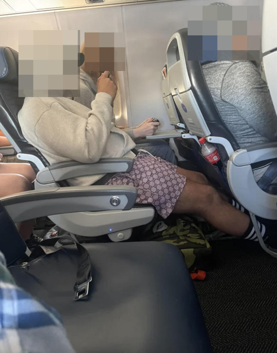 A blurred-out person on a plane