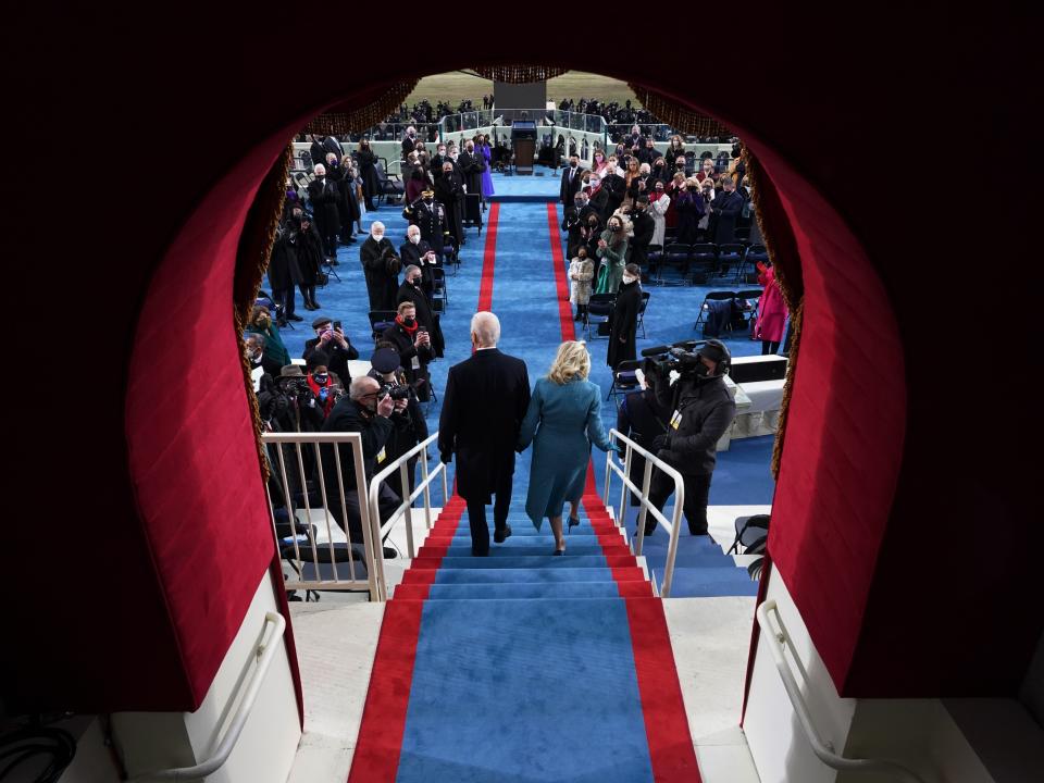 President Biden and wife Jill Biden descend the steps minutes before he officials became the 46th president EPA