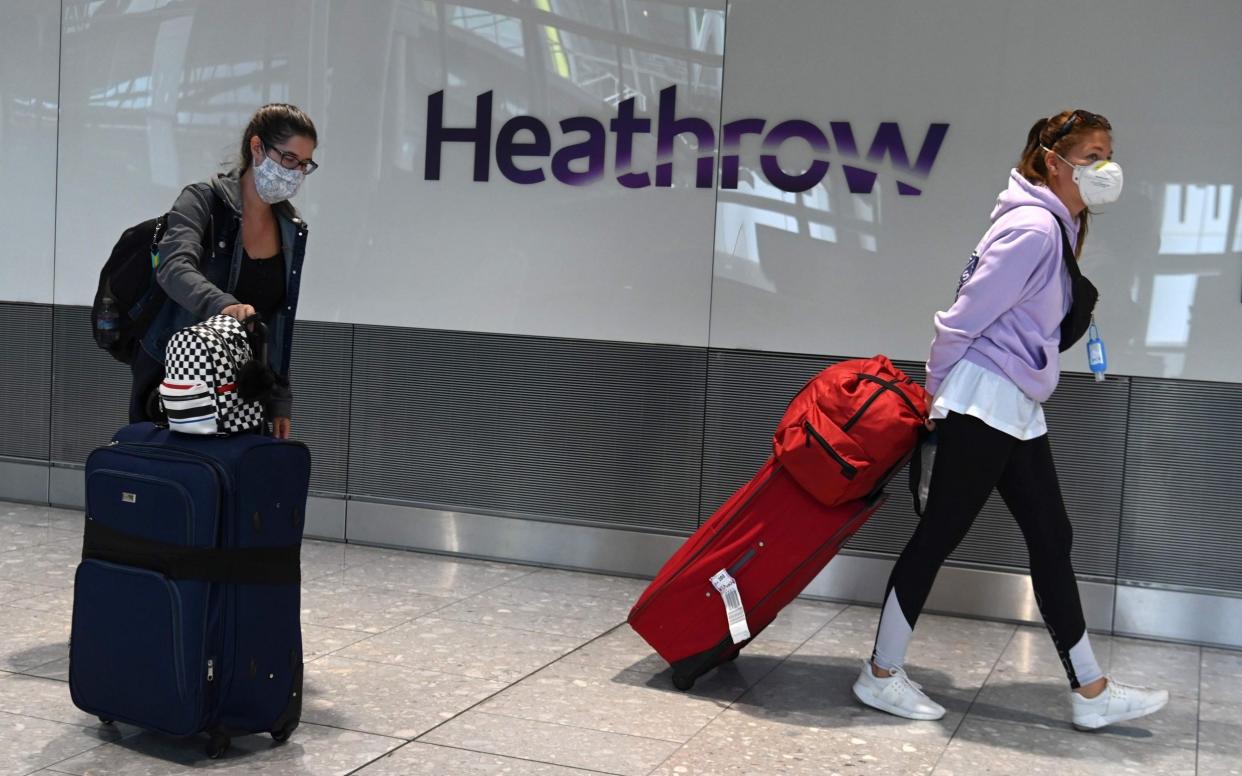 Passengers at Heathrow  - AFP
