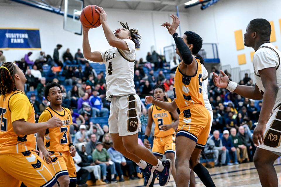 Holt's Isaiah Foster scores against Battle Creek Central during the third quarter on Monday, March 13, 2023, at DeWitt High School.