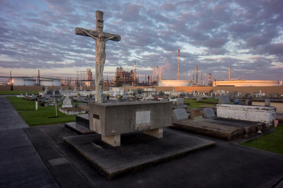A cemetery stands in stark contrast to the chemical plants that surround it October 15, 2013. 'Cancer Alley' is one of the most polluted areas of the United States and lies along the once pristine Mississippi River that stretches some 80 miles from New Orleans to Baton Rouge, where a dense concentration of oil refineries, petrochemical plants, and other chemical industries reside alongside suburban homes.