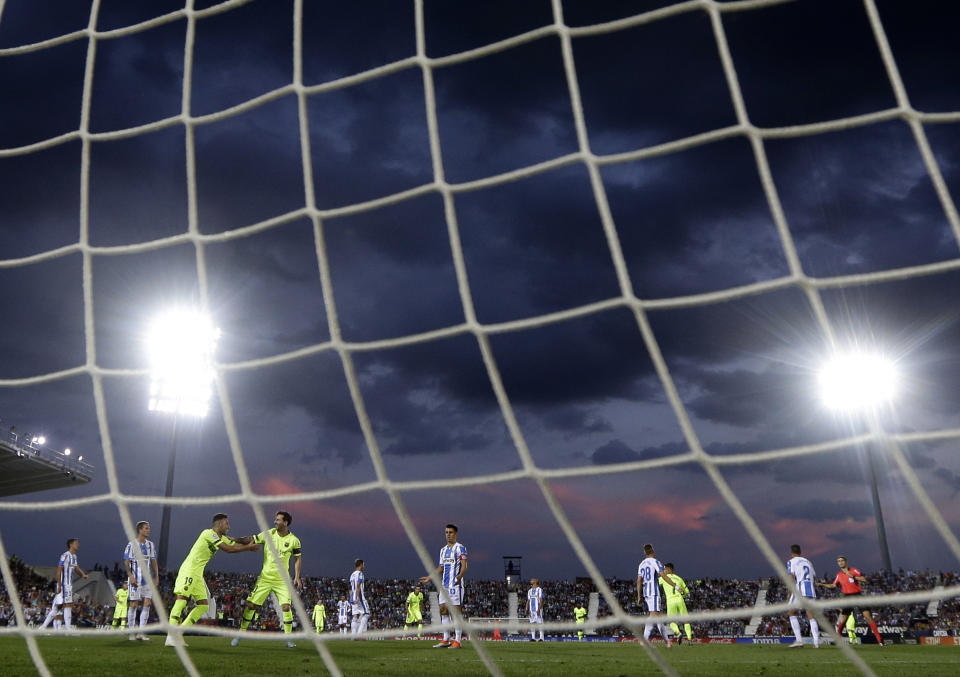 FC Barcelona's Lionel Messi, fourth left, celebrates Coutinho's goal during the Spanish La Liga soccer match between Leganes and FC Barcelona at the Butarque stadium in Leganes, Spain, Wednesday, Sept. 26, 2018. (AP Photo/Manu Fernandez)