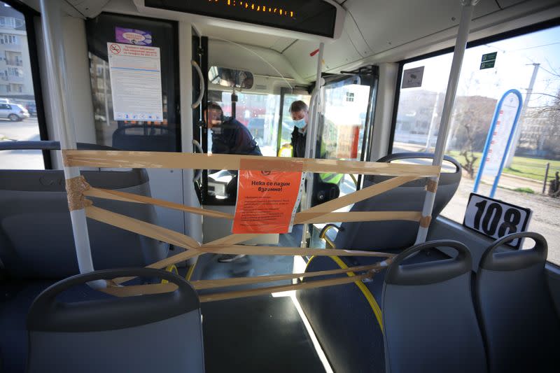 A Bulgarian public bus driver works behind restriction lines in Sofia after the Sofia Municipality imposed measures to curb the spread of coronavirus, in Sofia