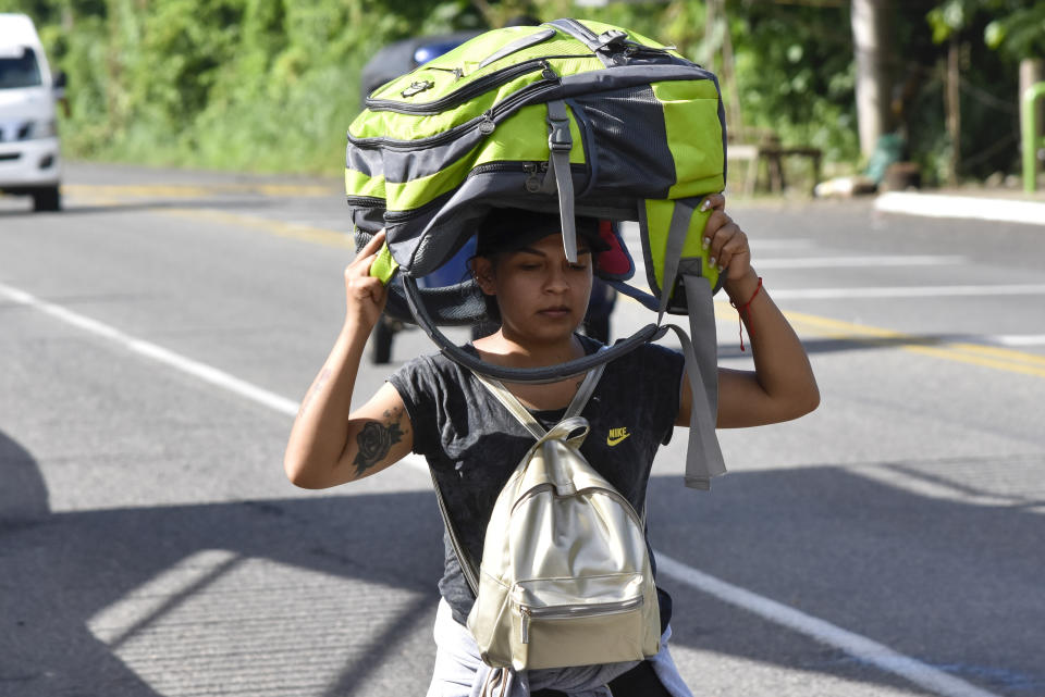 A migrant walks along the highway through Suchiate, Chiapas state in southern Mexico, Sunday, July 21, 2024, during their journey north toward the U.S. border. (AP Photo/Edgar H. Clemente)