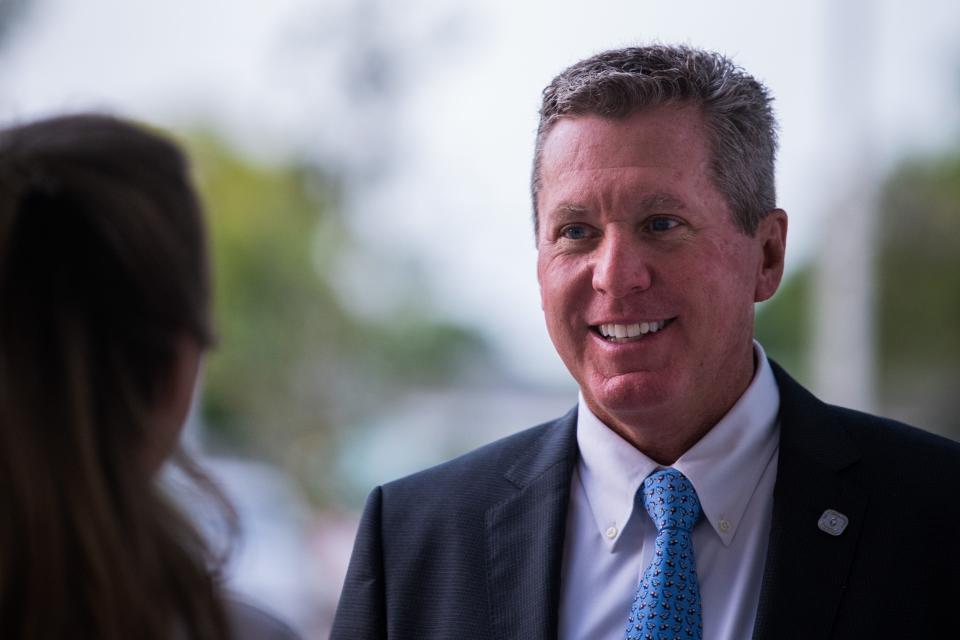 Palm Beach County Schools Superintendent Mike Burke speaks to an S.D. Spady Elementary School faculty member in Delray Beach on the first day of school Wednesday.